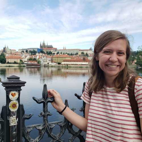 Megan Woodruff, smiling on a bridge in Prague, Czech Republic